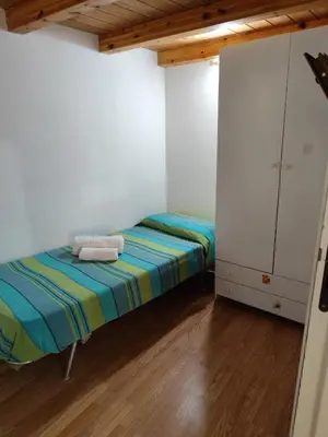 a small room with a bed and a cabinet at La Perla sul Golfo in Castellammare del Golfo