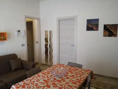 a living room with a table and a couch and a table at I due Archi in Castellammare del Golfo
