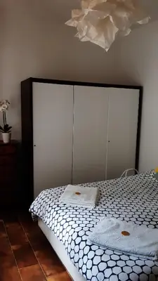 a bedroom with a large bed with a white comforter at Villa Maria in Mondello
