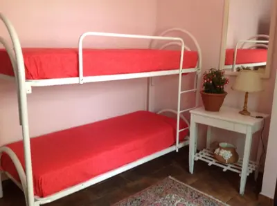 a room with two bunk beds and a table at Villa Maria in Mondello
