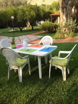 a picnic table with two chairs and a table with a quilt at Villa Maria in Mondello