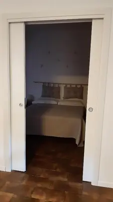 a bedroom with a bed with a door open at Villa Maria in Mondello