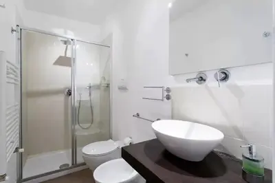 a bathroom with a sink and a toilet and a shower at BB4U Apartments in Palermo