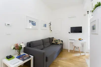 a living room with a couch and a table at BB4U Apartments in Palermo
