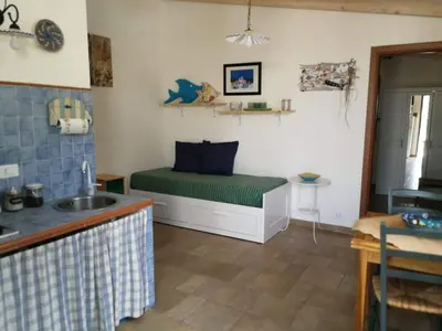a room with a bed in the corner of a room at Villa Rossana in Scopello