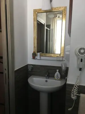 a bathroom with a sink and a mirror at Mondello Room in Mondello