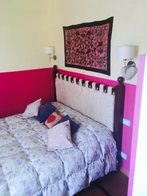 a bedroom with a bed with a red head board at Mondello Room in Mondello
