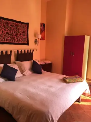 a bedroom with a large bed with a red cabinet at Mondello Room in Mondello