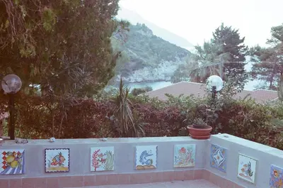a wall with pictures on it with a view of a river at Two Steps From The Sea in Scopello