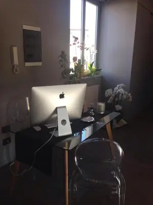 a desk with a laptop computer on top of it at Dimora Villareale in Palermo