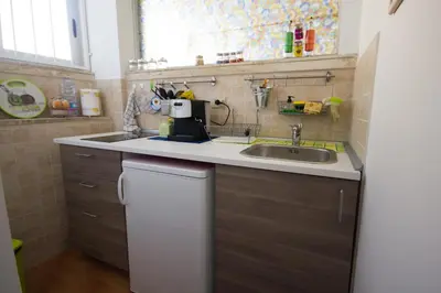 a small kitchen with a sink and a counter at Lunetta in Palermo