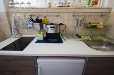 a kitchen counter with a coffee maker and a sink at Lunetta in Palermo
