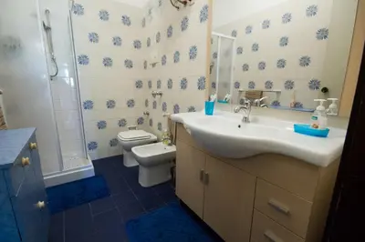 a bathroom with a sink and a toilet and a shower at Lunetta in Palermo