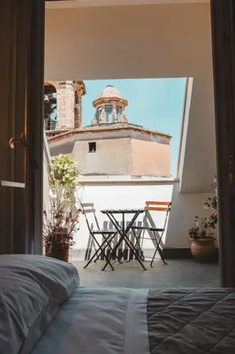 a table and chairs in a room with a building at Attico 261 - Penthouse in Palermo