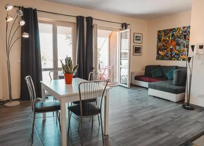 a living room with a table and chairs and a couch at Attico 261 - Penthouse in Palermo