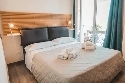 a bedroom with a large bed with towels on it at Attico 261 - Penthouse in Palermo