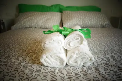 two towels are made to look like rabbits on a bed at Casamatta in Trappeto