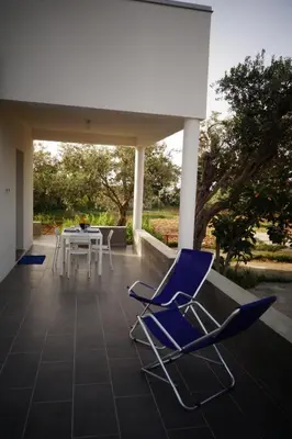 a pair of blue chairs sitting on a patio at Casamatta in Trappeto