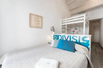 a kitchen and living room with a couch and a table at Divisi9 - apartment historic center Palermo in Palermo