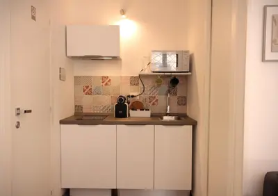 a kitchen counter with a microwave and a sink at Divisi9 - apartment historic center Palermo in Palermo