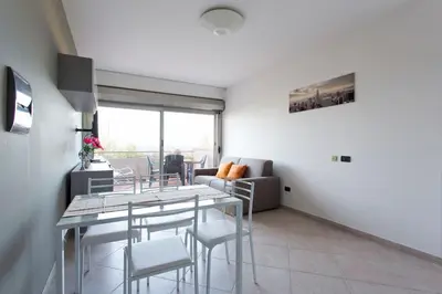 a living room with a dining table and chairs at Mondello Addaura Home Holiday in Mondello
