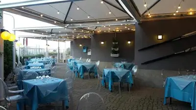 a dining room with blue tables and chairs at Mondello Addaura Home Holiday in Mondello