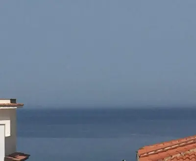 a view of the ocean from a building at Appartamento Nettuno in Castellammare del Golfo