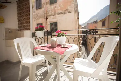 a white table and chairs on a balcony at Appartamento Nettuno in Castellammare del Golfo