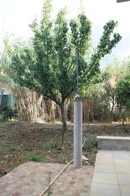 a pole with a light next to a tree at Lucy's cottage in Cinisi