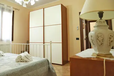 a bedroom with a bed and a lamp on a dresser at Lucy's cottage in Cinisi