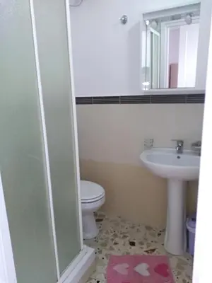 a bathroom with a toilet and a sink at Carpe Diem Apartments in Castellammare del Golfo