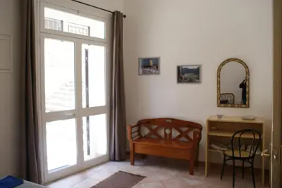 a room with a door and a desk and a chair at Aura Maris in Castellammare del Golfo