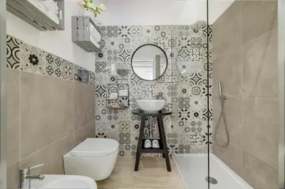 a bathroom with a toilet and a sink and a mirror at Hotel Soffio D'Estate in San Vito lo Capo
