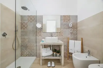 a bathroom with a sink and a toilet and a shower at Hotel Soffio D'Estate in San Vito lo Capo