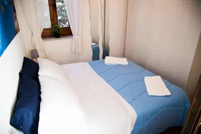 a bed in a small room with two pillows on it at Villa Buonasera in Santa Flavia