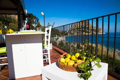 a basket of fruit on a table on a balcony at Villa Buonasera in Santa Flavia
