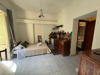a bedroom with a bed and a sink in it at Apartment Co in Palermo