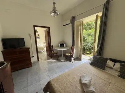 a bedroom with a bed and a television and a table at Apartment Co in Palermo