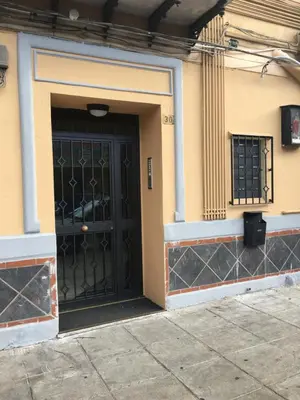 a black door on the side of a building at Apartment Co in Palermo