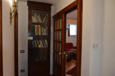 a door to a room with a book shelf filled with books at Villa Matilde in Carini