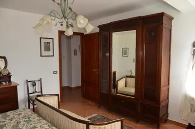 a living room with a large wooden cabinet with a mirror at Villa Matilde in Carini