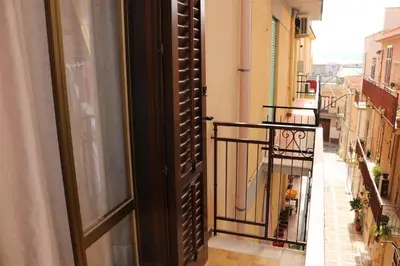 an open door to a balcony in a building at Casa Trio Apartments in Castellammare del Golfo