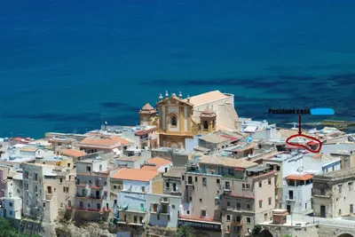 a group of buildings on a hill next to the ocean at Casa Trio Apartments in Castellammare del Golfo