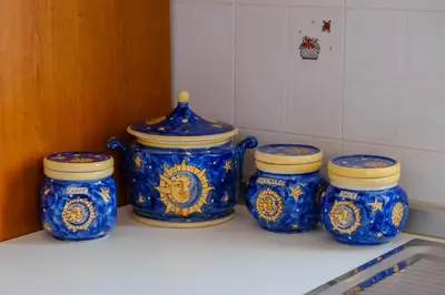 four blue and white jars sitting on a kitchen counter at La Casa delle Ginestre in Alcamo Marina