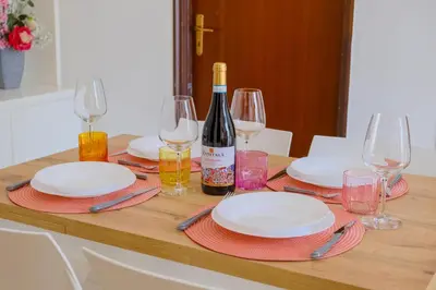 a table with plates and wine bottles and glasses at La Casa delle Ginestre in Alcamo Marina