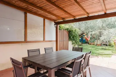 a wooden table and chairs on a patio at Villa 'Antico Baglio' - Scopello - Castellammare Del Golfo in Castellammare del Golfo