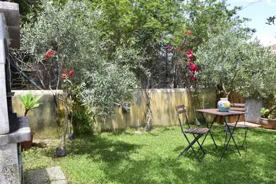 a garden with a table and chairs in the grass at Villa 'Antico Baglio' - Scopello - Castellammare Del Golfo in Castellammare del Golfo