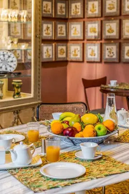 a table with a bowl of fruit on it at Le Stanze al Genio di Darlon in Palermo