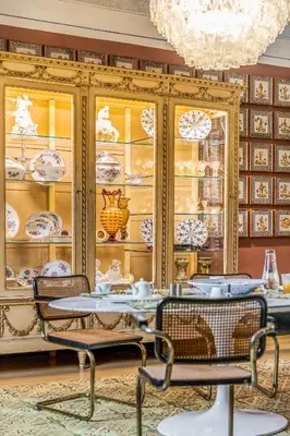 a dining room with a china cabinet with dishes at Le Stanze al Genio di Darlon in Palermo