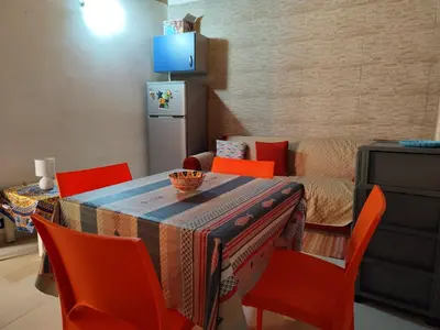 a kitchen with a table and chairs and a couch at La Marina in Castellammare del Golfo